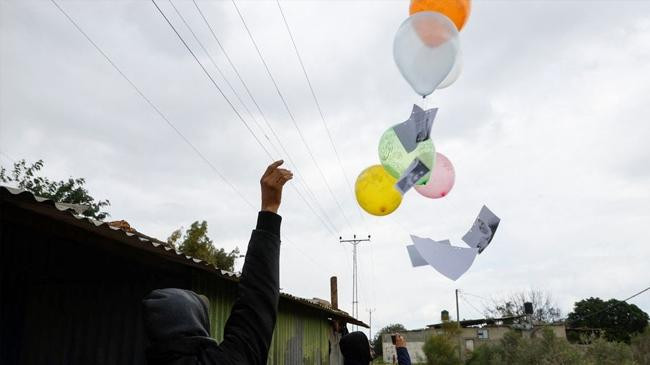 a demonstrator releases balloons erez crossing in the northern gaza strip