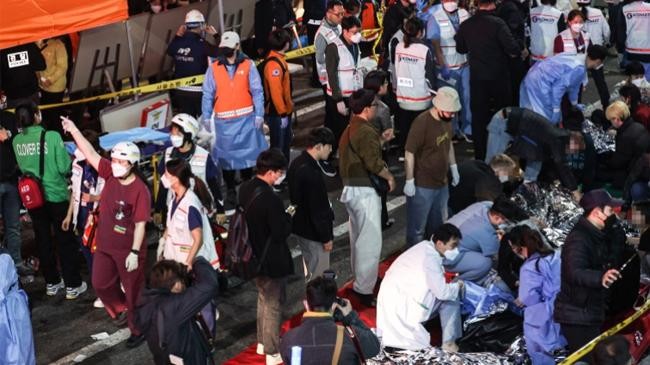 injured people are attended to on a street