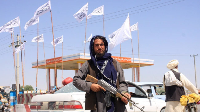 taliban fighter stands guard ghazni