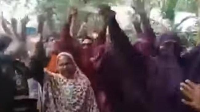 men dances wearing borqa election campign