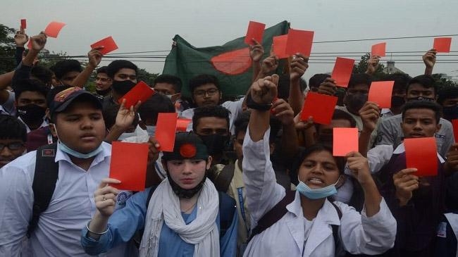 students showing red card road home