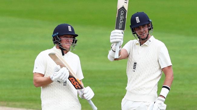 broad raises his bat