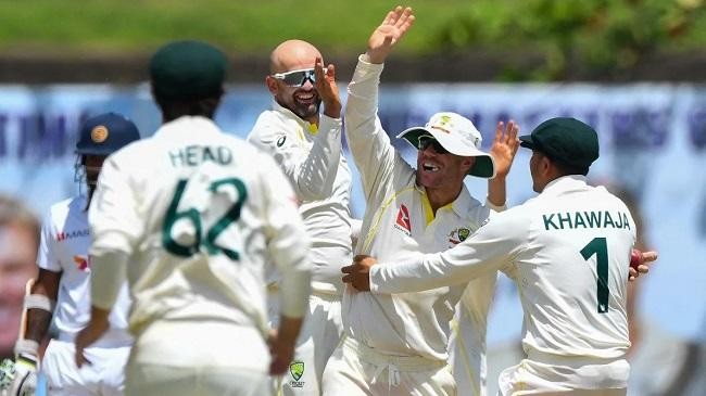 nathan lyon is mobbed by his teammates