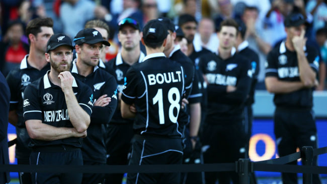 new zealand players watch on as england are crowned champions