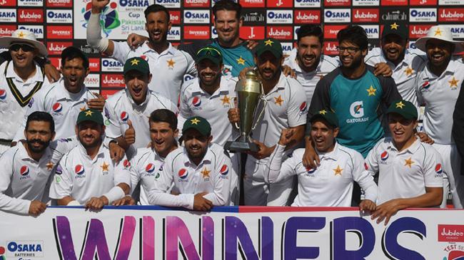 pakistan players pose with the trophy