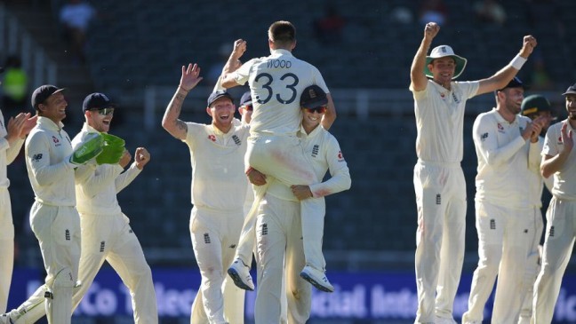 wood is lifted aloft after taking his final wicket