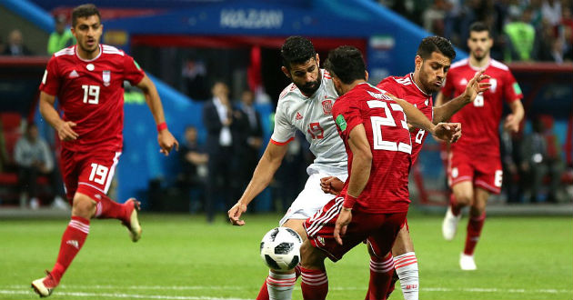 costa fights for ball against iran players