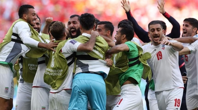 iran players celebrating against wales in world cup