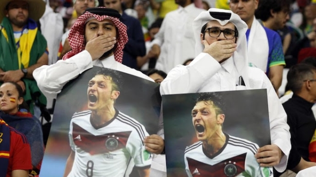 qatar fans hold mesut ozil signs at world cup