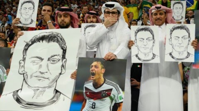 qatar fans hold mesut ozil signs at world cup 1