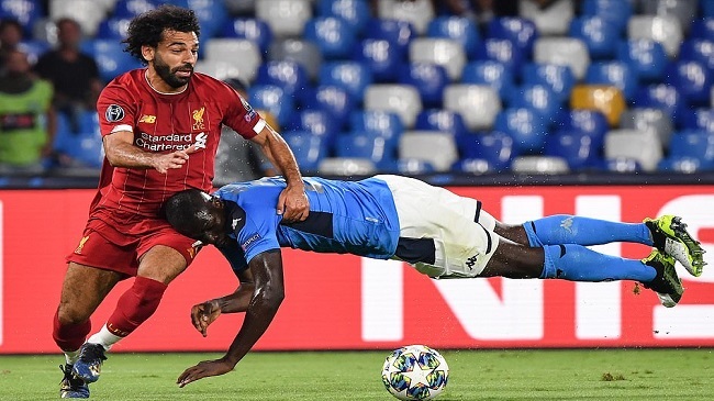 salah shrugs off a challenge from koulibaly