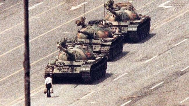 a chinese man in front of tank