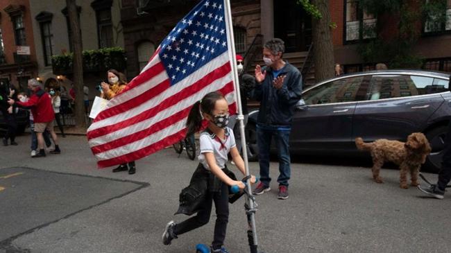 a girl carrying us flag