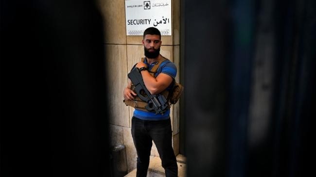 a lebanese state security officer stands guard at the entrance of the central bank