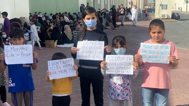 afghan children hold banners during a protest