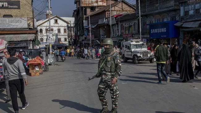 an indian paramilitary soldier patrols in srinagar