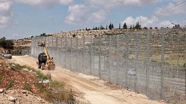 an israeli transported moves sections of a fence