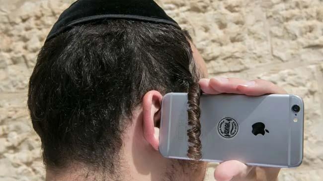 an ultra orthodox man with a smartphone