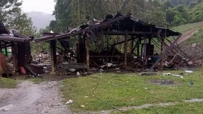 debris are scattered around destroyed wooden structures