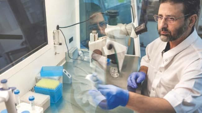 dr nisar ahmad wani examines a sample at his laboratory