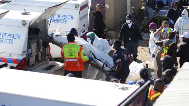 forensic personnel load bodies of the victims