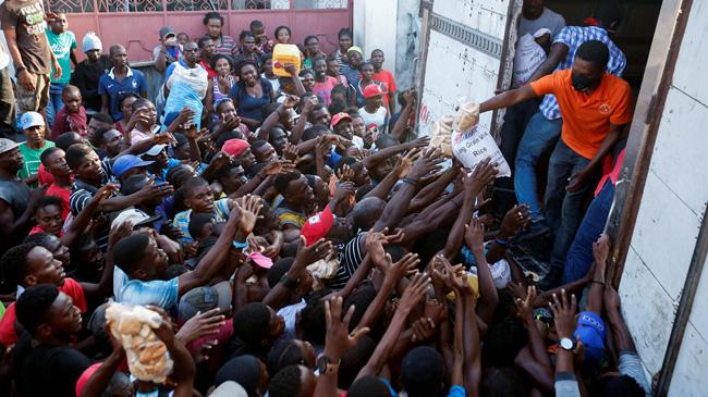 haitian people collecting relief