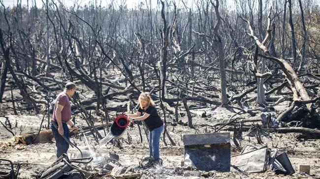 hector rivera and wandi blanco put water on hotspots behind their home