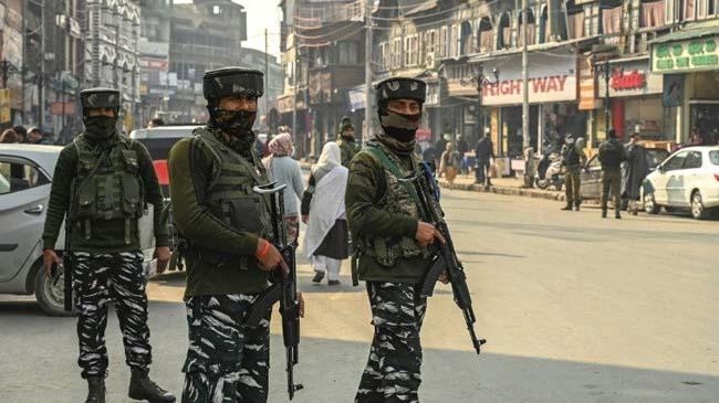 indian paramilitary troops stand guard on a street in srinagar