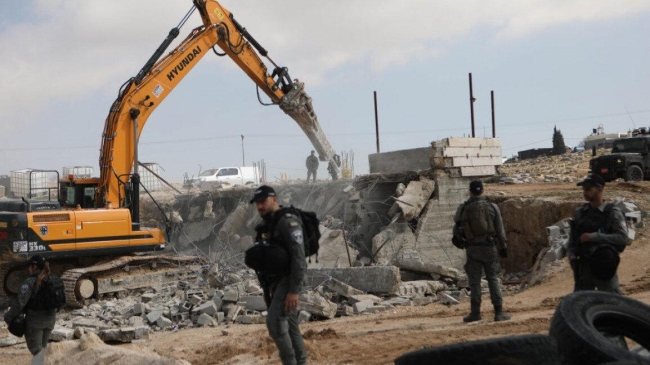 israeli forces demolish palestinian buildings