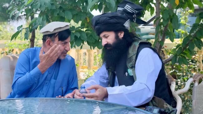 khalil ur rahman haqqani right sits with hashmat ghani