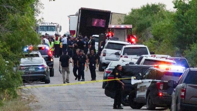 law enforcement officers work at the scene