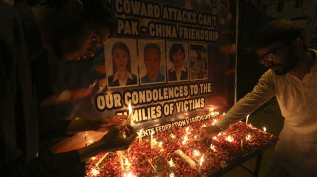 members of a student union light candle