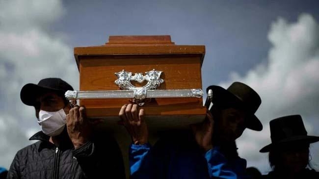 men carry a coffin at a funeral in peru