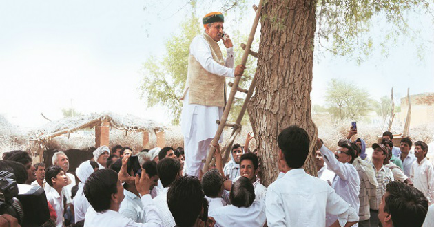 minister climb tree for mobile network