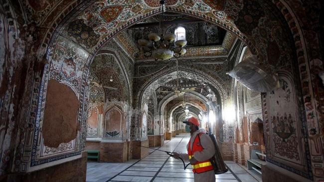 pakistan mosque a man is giving anticeptic