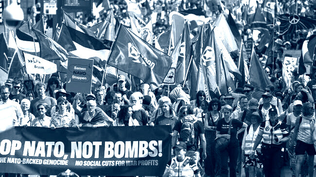 people carry banners and flags during a demonstration ahead of the nato summit