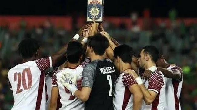 players at an iraqi league football match held up quran