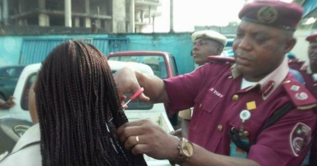 police officer cuts hair of women colleague