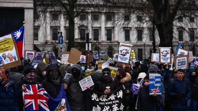 protesters gather with placards at the site of the former royal mint