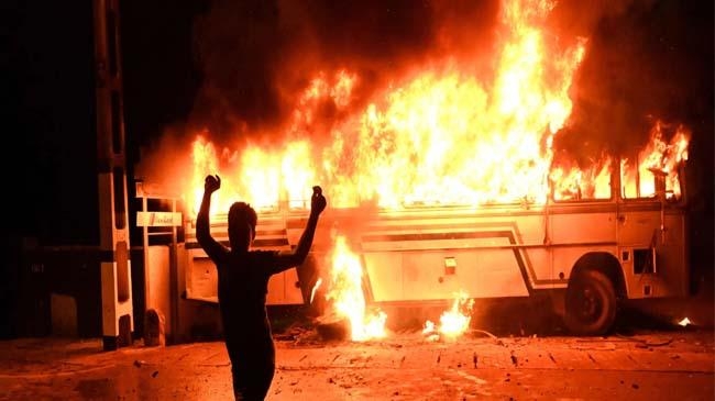 protestor burns a bus