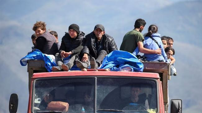 refugees from nagorno karabakh region ride in a truck
