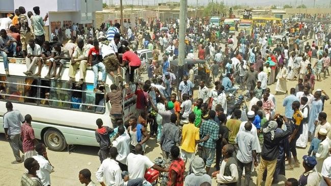 scores of hausa people gather outside local government offices