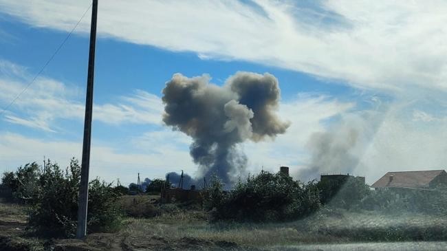 smoke rises after explosions were heard from the direction of a russian military airbase