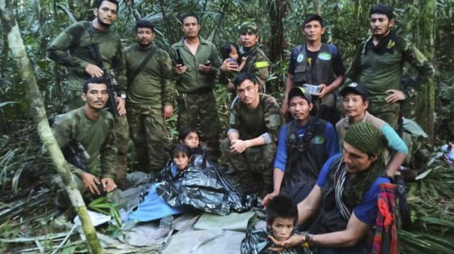 soldiers pose for a photo with the children