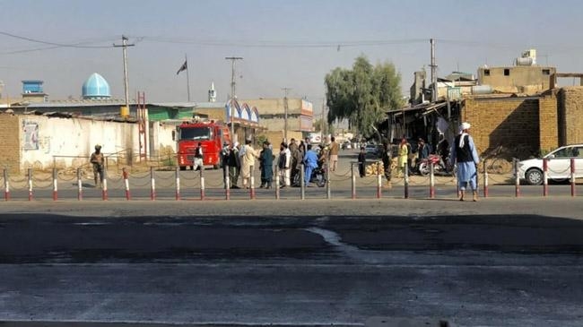 taliban members guard shia mosque kandahar