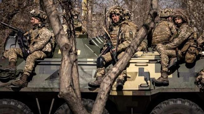 ukrainian soldiers sit on a military vehicule in severodonetsk donbas region