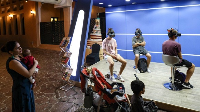 young football fans watch a five minute virtual reality tour of islam